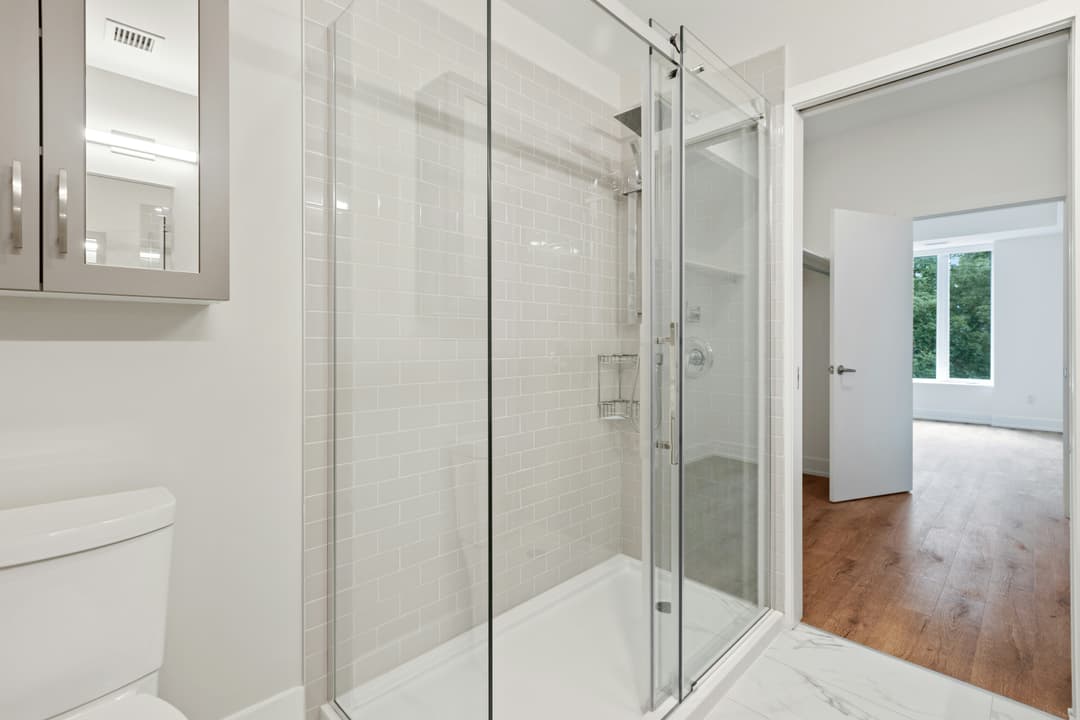 picture of a newly remodeled shower with glass walls and sliding glass doors
